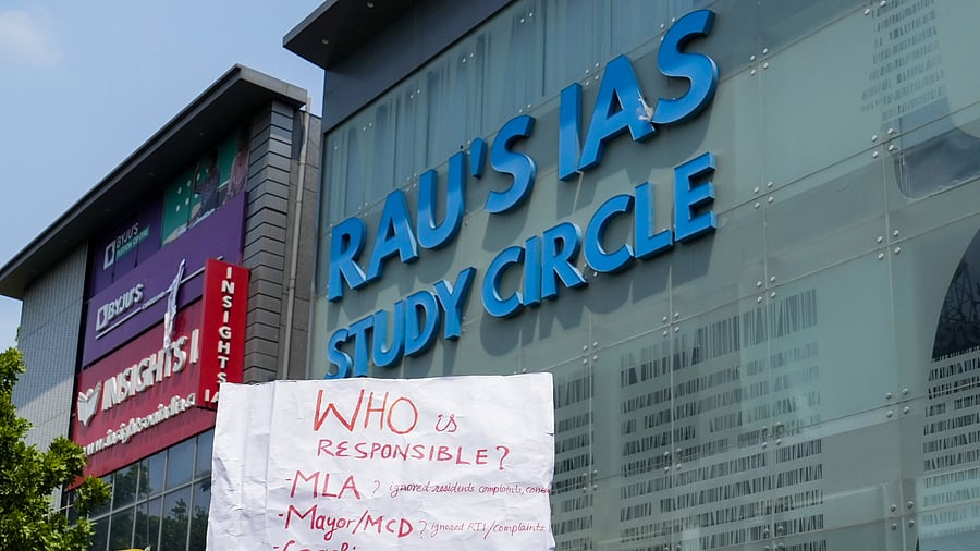 <div class="paragraphs"><p>A placard held by a student during a protest after three civil services aspirants died due to drowning at a coaching centre in Old Rajinder Nagar area, in New Delhi.&nbsp;</p></div>